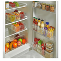 Clear fridge organizer bins neatly arranged in a bright refrigerator with fresh produce and condiments